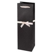 Black paper wine gift bag with white polka dots and a white bow on the handle